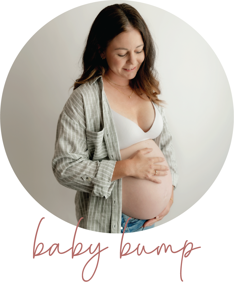 pregnant mother holder her bump posing for a photo